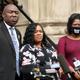 Breonna Taylor’s mother Tamika Palmer (C) addresses the media over the speed of the investigation of her daughter’s death as attorney Benjamin Crump (L) and co-counsel Lonita Baker (R) looks on outside Louisville City Hall on August 13, 2020, in Louisville, Kentucky.